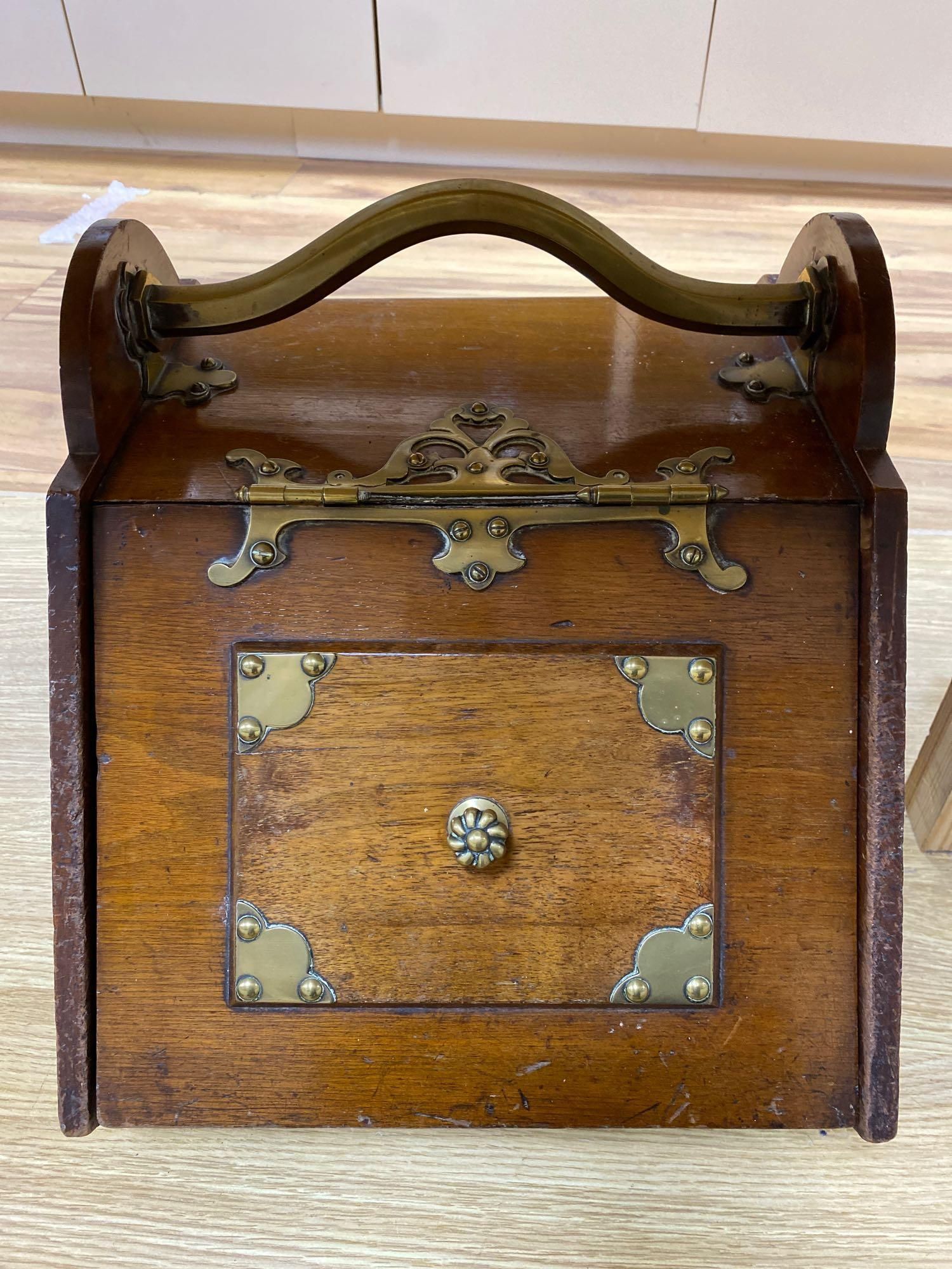 A Gothic revival walnut and brass mounted coal box on ceramic casters, 35cm wide